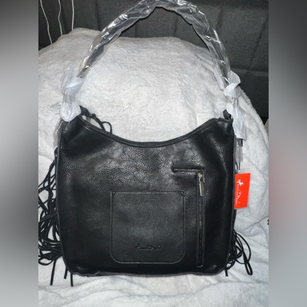 Montana west hobo bag with a beautiful tassle/ flower carved detail